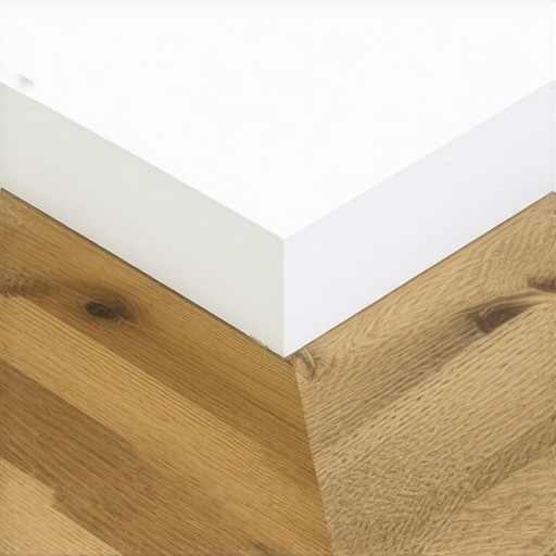 Professional Scarf Joint for Baseboards Close-up of a 45-degree scarf joint in white baseboard trim showing the overlap and glue application.